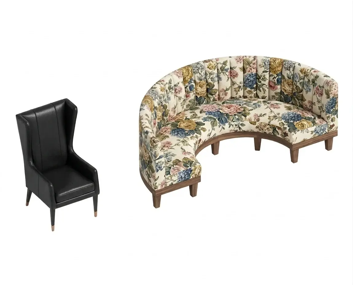 A black leather wingback chair and a curved booth in floral fabric imported into Revit, shown textured in a 3D view
